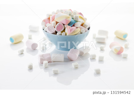 Colorful marshmallows in a bowl on white table background. Colorful marshmallows in a bowl on white table background. 131594542