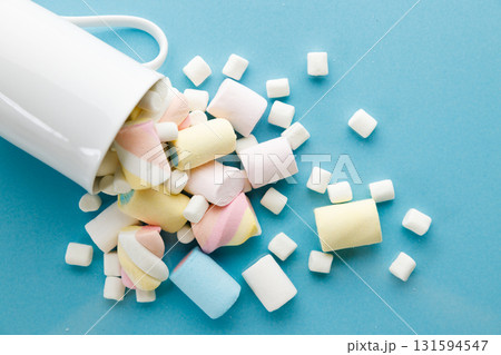 Colorful marshmallows on a vibrant blue background. 131594547