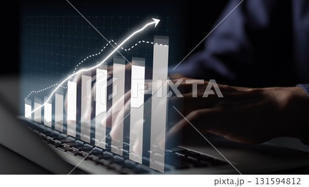 Hands typing on a laptop with a digital graph overlay showcasing an upward trend in business growth and financial success, representing technology and innovation Copula Hands typing on a laptop with a digital graph overlay showcasing an upward trend in business growth and financial success, representing technology and innovation Copula 131594812
