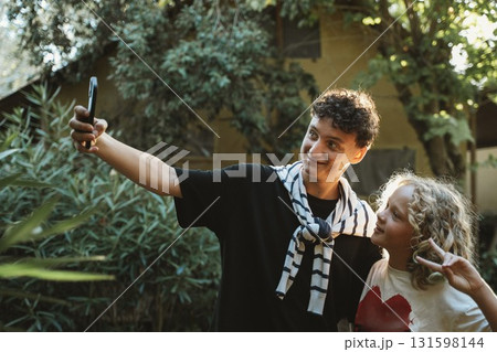 Brother and Sister Taking a Selfie Outdoors Brother and Sister Taking a Selfie Outdoors 131598144