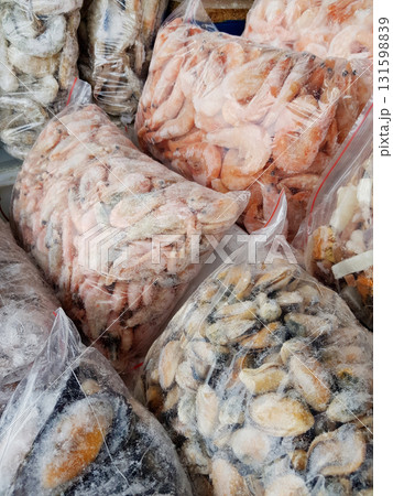 A variety of frozen seafood in plastic bags at the fish market 131598839