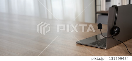 Customer support headset resting on laptop in modern office, daylight bokeh, symbolizing call center service, helpline communication, remote work, and tech assistance. Customer support headset resting on laptop in modern office, daylight bokeh, symbolizing call center service, helpline communication, remote work, and tech assistance. 131599484