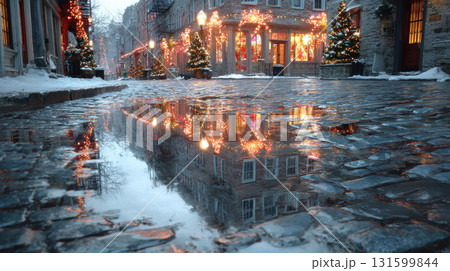 Christmas street with lights and snow reflecting on wet cobblestone 131599844