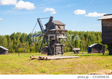 Historic Wooden Windmill with Large Blades under Blue Sky 131600616