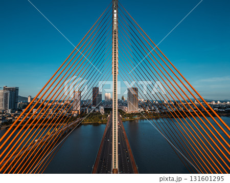 Symmetric modern cable-stayed bridge over Han River in Da Nang, Contemporary urban span connecting city skyline across Vietnamese waterway Symmetric modern cable-stayed bridge over Han River in Da Nang, Contemporary urban span connecting city skyline across Vietnamese waterway 131601295
