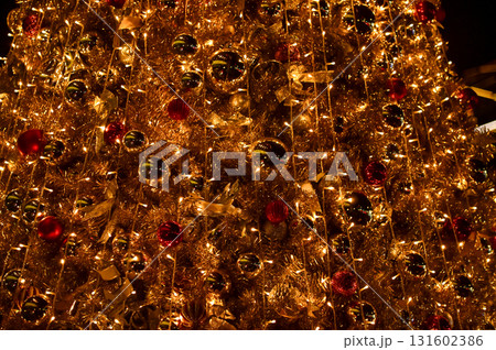 Close-up of the Christmas trees with colorful ornaments. Festive decoration. Full of ornaments. Winter season, winter festive. Christmas celebration, Xmas celebration. For background use. Close-up of the Christmas trees with colorful ornaments. Festive decoration. Full of ornaments. Winter season, winter festive. Christmas celebration, Xmas celebration. For background use. 131602386