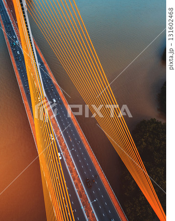 Symmetric modern cable-stayed bridge over rive, Contemporary urban span connecting city across waterway Symmetric modern cable-stayed bridge over rive, Contemporary urban span connecting city across waterway 131602468