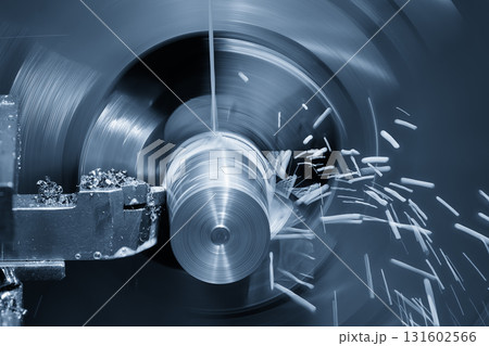 The lathe machine finish cut metal shaft parts with liquid coolant method in the light blue scene. 131602566