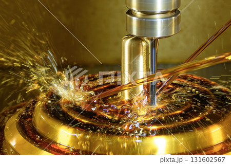 Close up scene the CNC milling machine finishing cut the brass shell mold parts with oil coolant method. 131602567