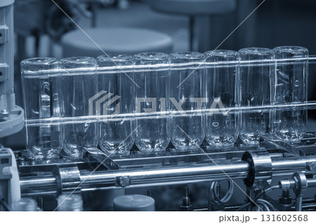 The series of clear plastic bottles are subsequently heated and blown in a blow molding process. 131602568