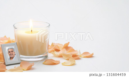 Candle with photo and marigold petals isolated on white background, ideal for remembrance visuals and spiritual designs 131604459