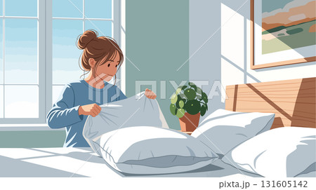 Young woman putting pillowcase on pillow 131605142