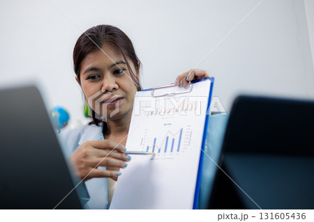 Businesswoman presenting data analysis report and sales graph in online meeting Businesswoman presenting data analysis report and sales graph in online meeting 131605436