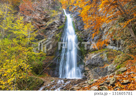 The Sutovsky waterfall in The Mala Fatra national park in Slovakia, Europe. Autumn Waterfall: Cascading water plunges down a rocky cliff surrounded by vibrant fall foliage. 131605781