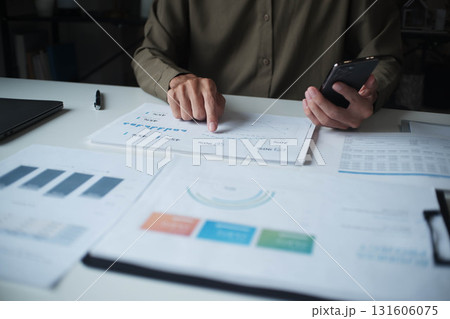 Businessman reading report in office desk analyze data for plan project Businessman reading report in office desk analyze data for plan project 131606075