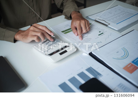 Businesswoman, entrepreneur, accountant working on financial report on desk using calculator. Businesswoman, entrepreneur, accountant working on financial report on desk using calculator. 131606094