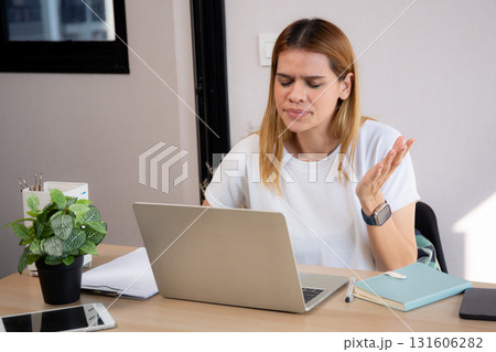 Unhappy young caucasian businesswoman using laptop computer on desk with stress and burnout. Unhappy young caucasian businesswoman using laptop computer on desk with stress and burnout. 131606282
