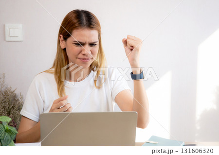 Unhappy young caucasian businesswoman using laptop computer on desk with stress and burnout. Unhappy young caucasian businesswoman using laptop computer on desk with stress and burnout. 131606320