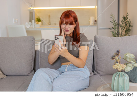 Young woman with smartphone toothache holds cheek searches dentist contacts and books online visit 131606954