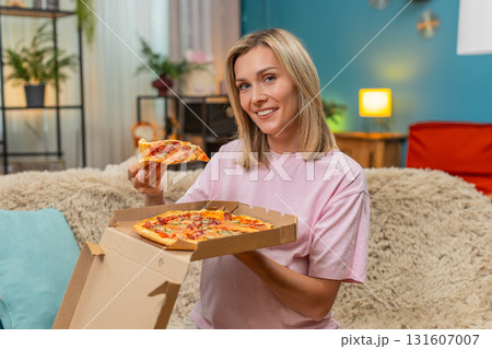 Pregnant woman opening pizza box inhaling hot aroma biting slice smiling enjoying delicious dinner Pregnant woman opening pizza box inhaling hot aroma biting slice smiling enjoying delicious dinner 131607007