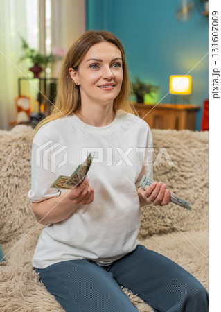 Pregnant woman counts dollars cash planning baby birth budget serious money management preparation Pregnant woman counts dollars cash planning baby birth budget serious money management preparation 131607009