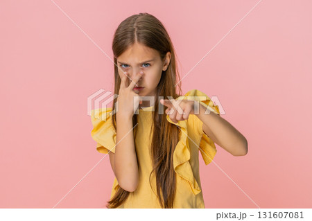 Child girl kid making serious face and showing watching gesture with fingers pointing at her eyes 131607081