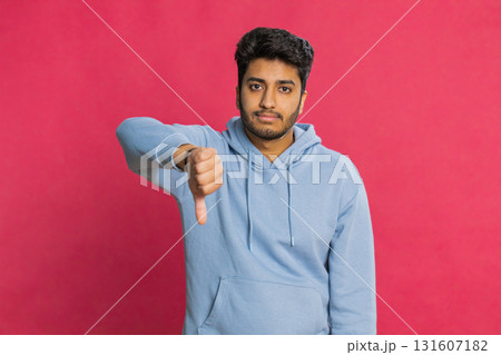 Upset man guy showing thumbs down gesture disapproval dissatisfied dislike negative feedback Upset man guy showing thumbs down gesture disapproval dissatisfied dislike negative feedback 131607182