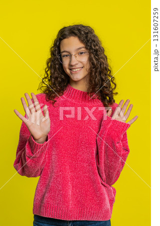 Happy girl smiling friendly waving hands gesturing hello greeting or goodbye, meeting invitation Happy girl smiling friendly waving hands gesturing hello greeting or goodbye, meeting invitation 131607259