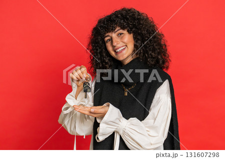 Caucasian woman real estate agent showing keys of new home house apartment, buying renting property 131607298