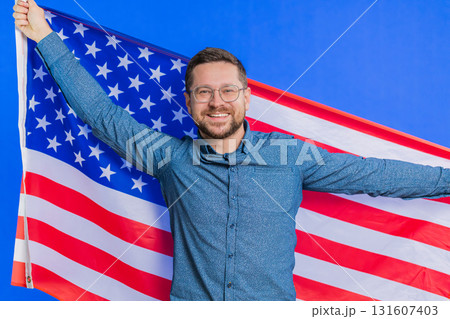 Man in glasses waving and wrapping in American USA flag, celebrating, human rights and freedoms 131607403