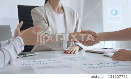 Professional business team clapping hands, celebrating successful presentation, displaying collaborative spirit and workplace enthusiasm in modern office setting 131607721