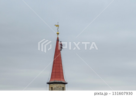 A climber is working of the tower. A climber is working of the tower. 131607930