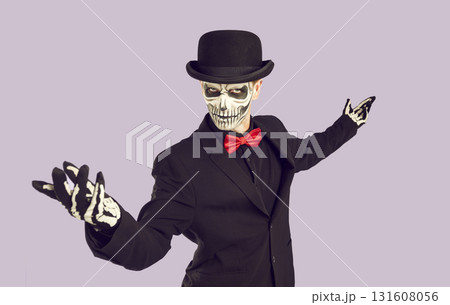 Man in skeleton costume does welcoming gesture and invites you to Halloween party 131608056