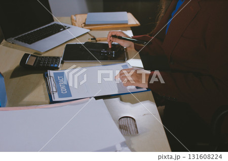Customer signing a real estate contract in real estate agency. Customer signing a real estate contract in real estate agency. 131608224