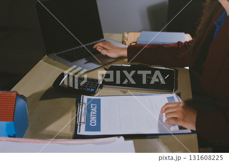 Customer signing a real estate contract in real estate agency. Customer signing a real estate contract in real estate agency. 131608225