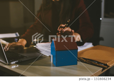 Customer signing a real estate contract in real estate agency. 131608234