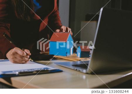 Customer signing a real estate contract in real estate agency. Customer signing a real estate contract in real estate agency. 131608244