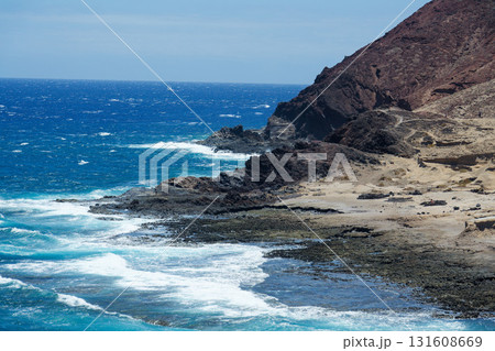 Dramatic cliffs around Montana Bocinegro and Montana Roja mountain, Tenerife coast near El Medano, Canary Islands, Spain, sunny summer day Dramatic cliffs around Montana Bocinegro and Montana Roja mountain, Tenerife coast near El Medano, Canary Islands, Spain, sunny summer day 131608669