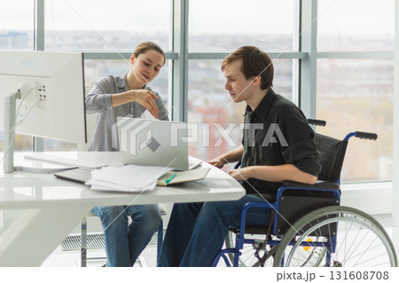 Colleagues business people woman man in chair for people with disability working on office. Startup business group team working together. Corporate professional team discussing project ideas 131608708