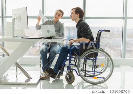 Colleagues business people woman man in chair for people with disability working on office. Startup business group team working together. Corporate professional team discussing project ideas Colleagues business people woman man in chair for people with disability working on office. Startup business group team working together. Corporate professional team discussing project ideas 131608709