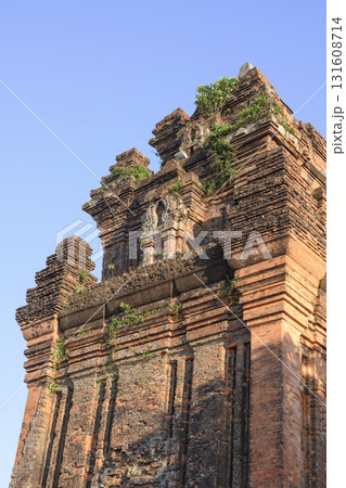 Ancient sacred Cham Tower of 12 century overgrown with grass and small trees in Tuy Hoa, Vietnam Ancient sacred Cham Tower of 12 century overgrown with grass and small trees in Tuy Hoa, Vietnam 131608714