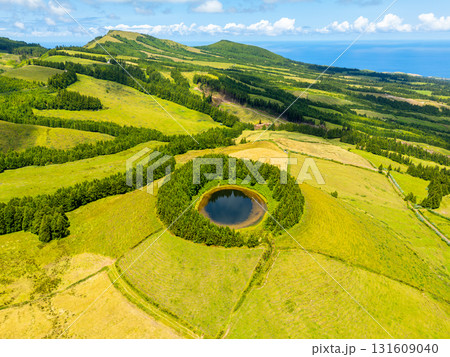 Lake Pau Pique and Lush Green Hills. Atlantic Ocean, Azores, Sao Miguel Island. Portugal. Aerial 131609040