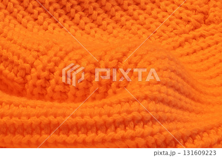 A close up of a knitted orange sweater A close up of a knitted orange sweater 131609223