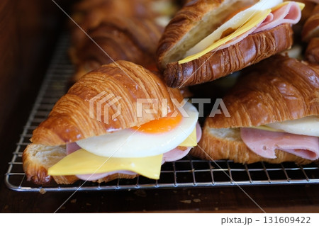 Ham cheese scrambled eggs croissant for breakfast. toning Ham cheese scrambled eggs croissant for breakfast. toning 131609422