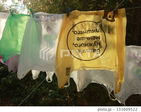 plastic shopping bags are drying on a rope outside on a sunny summer day 131609522