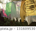 plastic shopping bags are drying on a rope outside on a sunny summer day 131609530