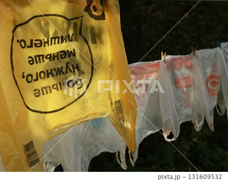 plastic shopping bags are drying on a rope outside on a sunny summer day plastic shopping bags are drying on a rope outside on a sunny summer day 131609532