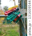 Colorful plastic clothespins on a rope outside 131609544