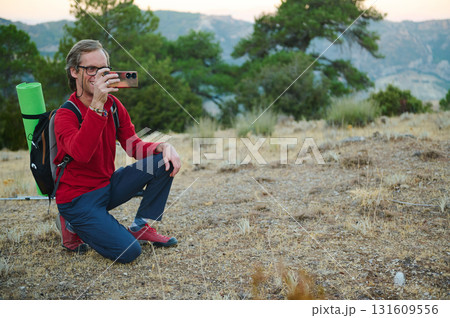Hiker Takes Photo With Smartphone On Trail, Outdoor Adventure Scene Hiker Takes Photo With Smartphone On Trail, Outdoor Adventure Scene 131609556