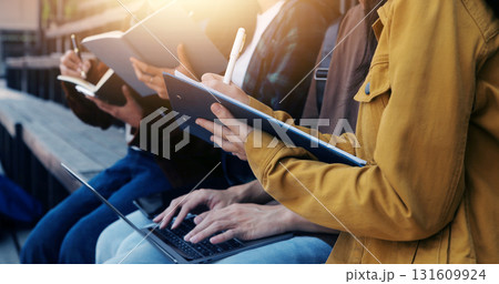 Happy students walking together on university campus, chatting and laughing outdoors after classes 131609924